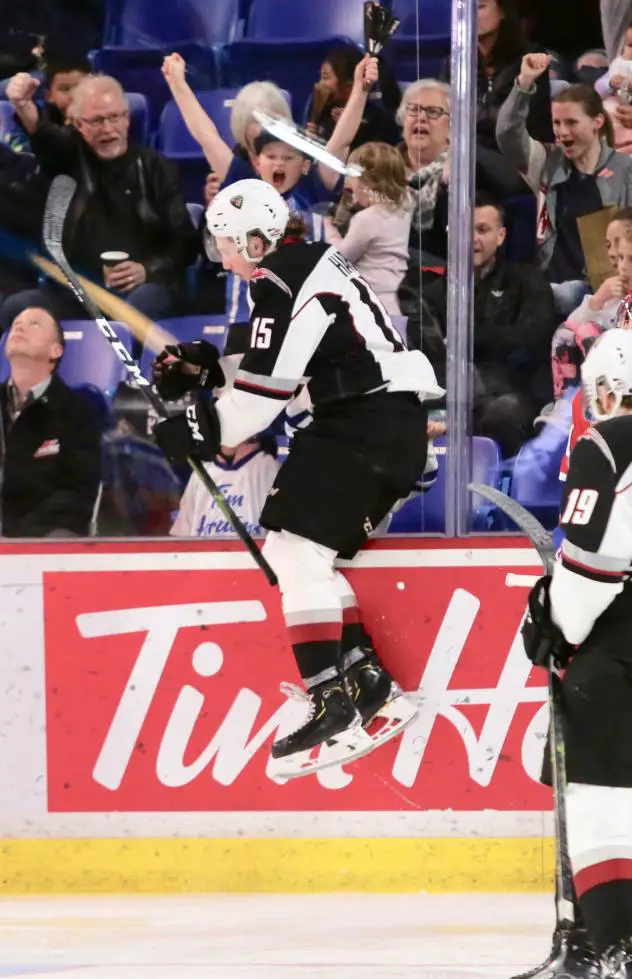 Owen Hardy of the Vancouver Giants jumps against the glass after a goal