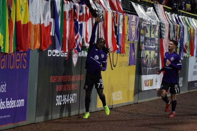 Louisville City FC forward Lucky Mkosana high fives fans