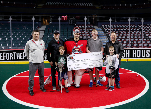 Roughnecks and Ascent Consulting Ltd. Direct present check for $14,180 to KidSport Calgary