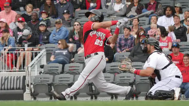 Eddie Silva of the Carolina Mudcats connects against the Fayetteville Woodpeckers