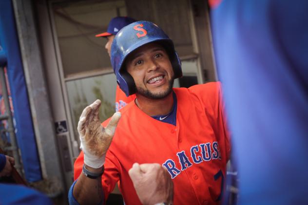 Grégor Blanco celebrates in the Syracuse Mets dugout after homering to lead off the bottom of the first inning on Tuesday night