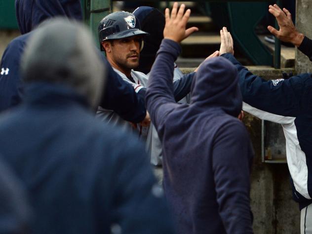 Alfredo Rodriguez of the Somerset Patriots receives high fives following his homer