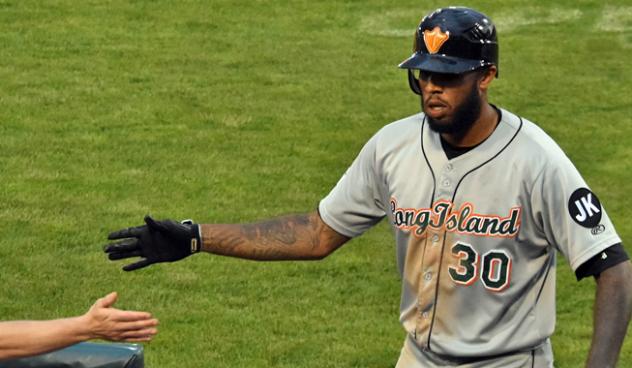 David Washington of the Long Island Ducks receives congratulations after a homer