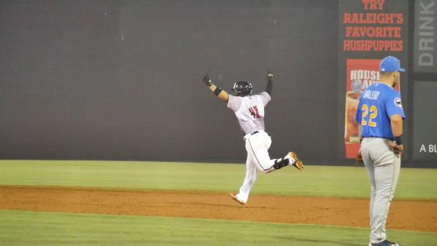 Mario Feliciano of the Carolina Mudcats rounds the bases after his walk-off homer