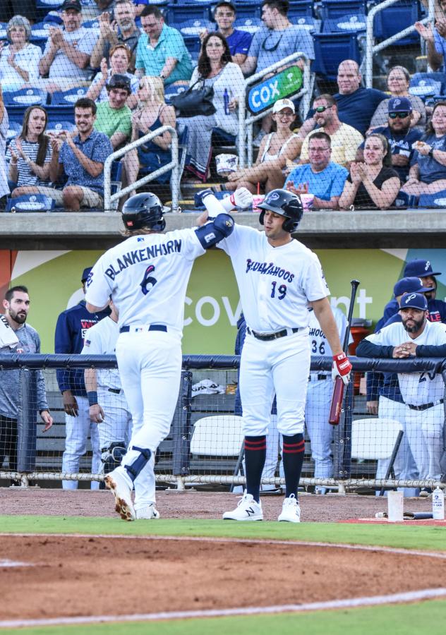 Travis Blankenhorn of the Pensacola Blue Wahoos receives congratulations after a home run
