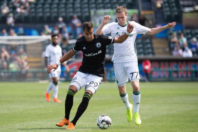Tacoma Defiance forward Justin Dhillon (left) battles for possession