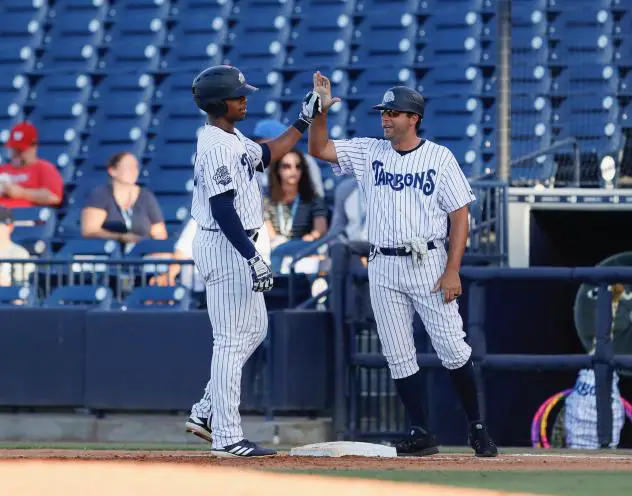 Isiah Gilliam and Kevin Mahoney of the Tampa Tarpons exchange a high five