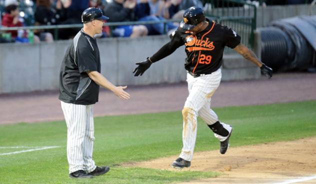 Daniel Fields gets a low five from Long Island Ducks player/coach Lew Ford