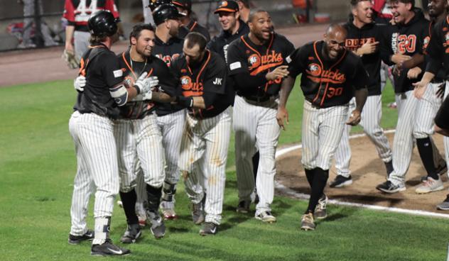 Long Island Ducks mob L.J. Mazzilli after he scored the game-winning run