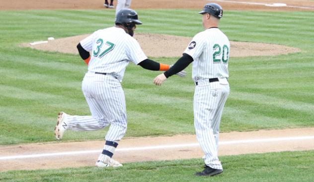 Hector Sanchez of the Long Island Ducks receives congratulations while circling the bases