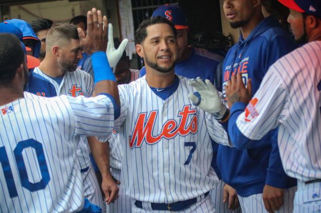 Gregor Blanco celebrates with his Syracuse Mets teammates in the dugout during Sunday's game