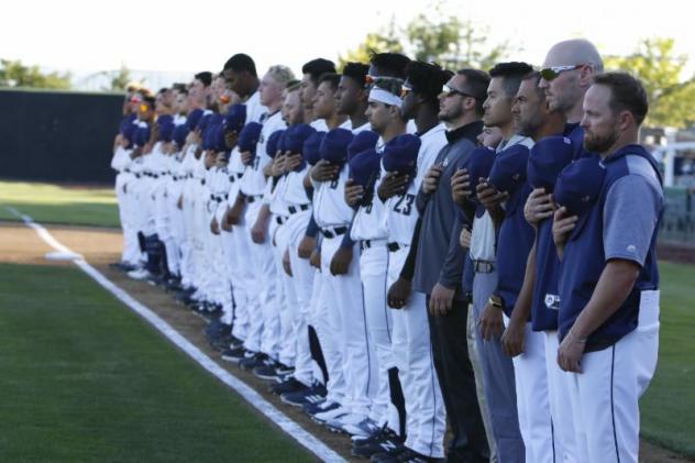 Tri-City Dust Devils stand for the National Anthem