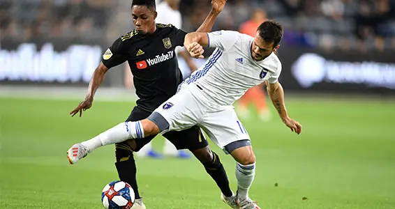 Dan Jose Earthquakes midfielder Vako (right) battles for possession with LAFC's Latif Blessing