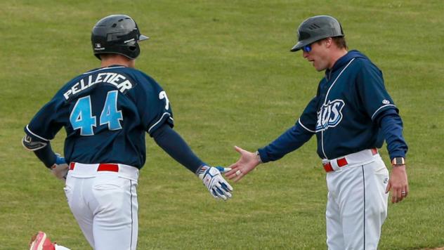 Ben Pelletier receives a low five after his home run