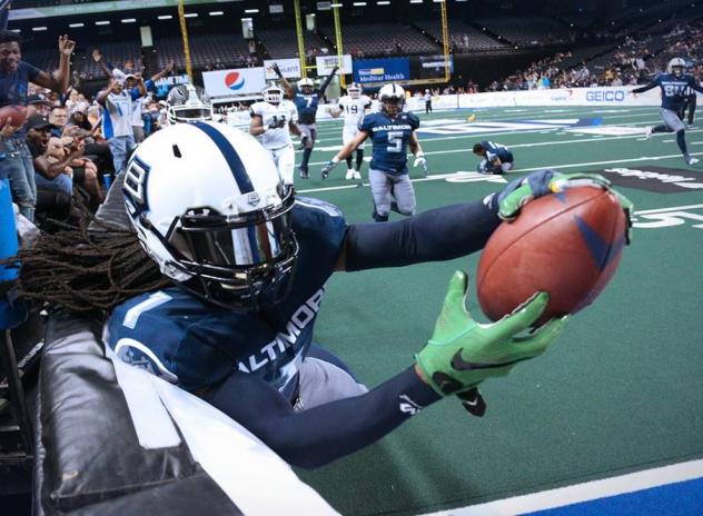 Baltimore Brigade dive for a touchdown against the boards