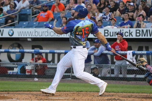 Tim Tebow of the Syracuse Mets (in SpongeBob SquarePants jersey) watches his home-run ball fly over the center-field wall