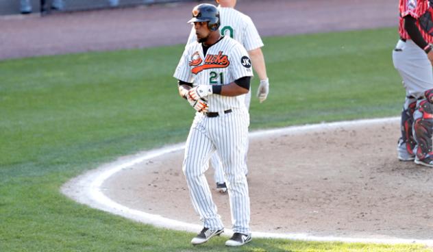 Deibinson Romero walks back to the dugout after scoring for the Long Island Ducks