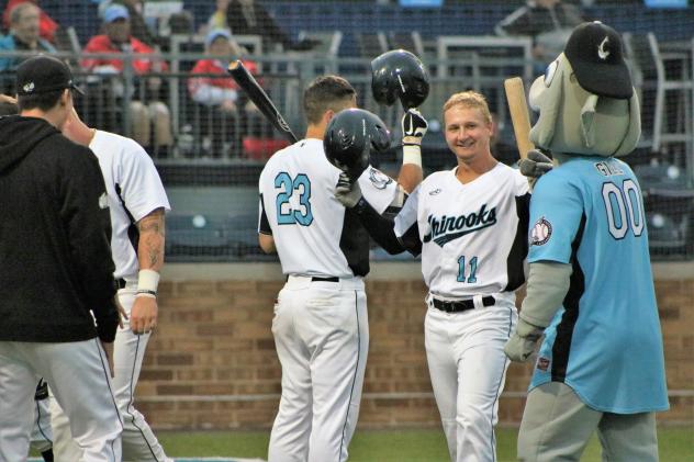 Lakeshore Chinooks infielders Daryl Myers (23) and Cole Barr (11)