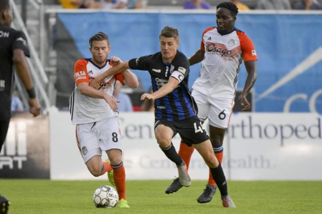 Colorado Springs Switchbacks FC race for the ball vs. the Tulsa Roughnecks