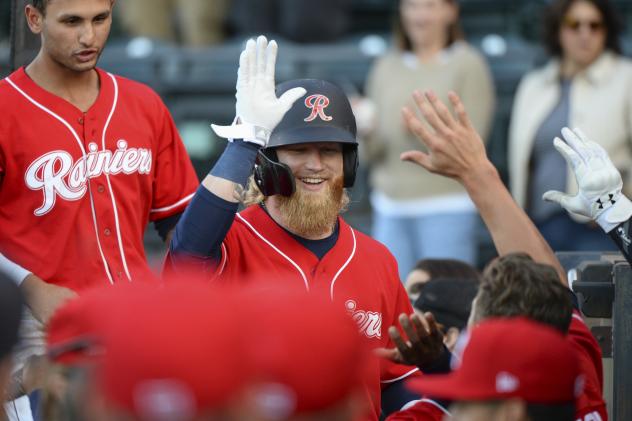 Jake Fraley of the Tacoma Rainiers receives congratulations in the dugout
