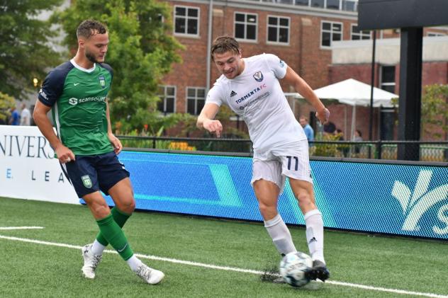 South Georgia Tormenta FC midfielder Charlie Dennis (right) vs. Greenville Triumph SC