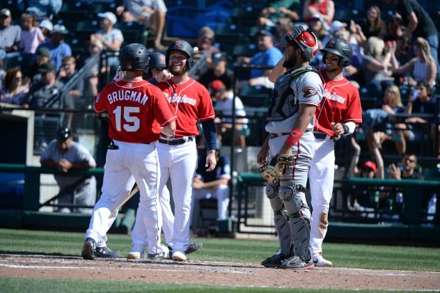 Jaycob Brugman of the Tacoma Rainiers receives congratulations after a home run