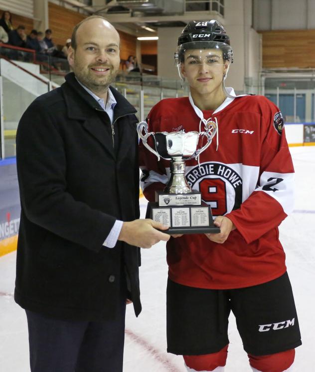 Vancouver Giants' Peter Toigo presents the Legends Cup to Tanner Brown