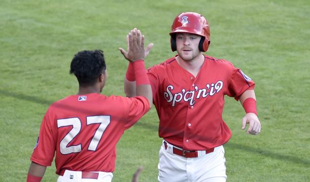 Blaine Crim of the Spokane Indians receives congratulations from Derwin Barreto (27) following Crim's grand slam