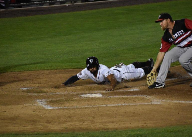 Michael Crouse of the Somerset Patriots scores on a wild pitch