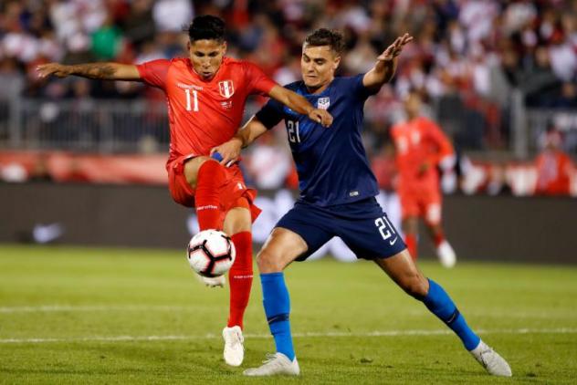 Seattle forward Raul RuidiÂaz, left, battles New York Red Bulls and U.S. Men's National Team defender Aaron Long