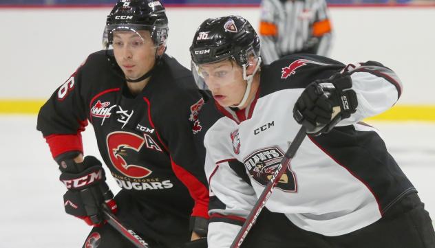 Vancouver Giants right wing Justin Lies (right) vs. the Prince George Cougars