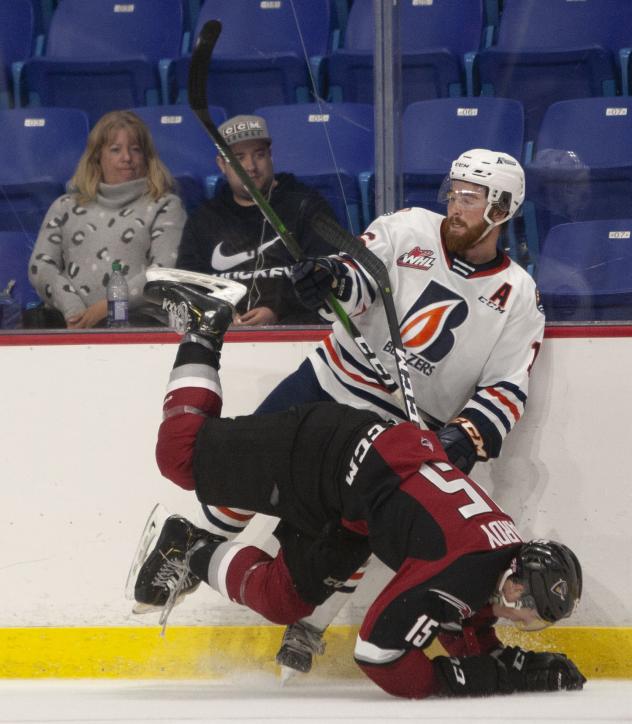 Vancouver Giants left wing Owen Hardy battles the Kamloops Blazers