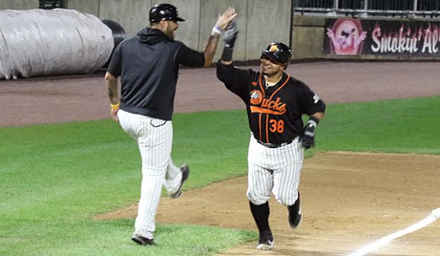 Ramon Cabrera of the Long Island Ducks gets a high five from Hector Sanchez as he rounds the bases