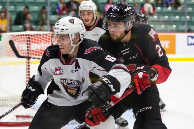 Vancouver Giants defenceman Dylan Plouffe fends off the Prince George Cougars