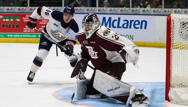 Peterborough Petes goaltender Hunter Jones faces Saginaw Spirit left wing Damien Giroux