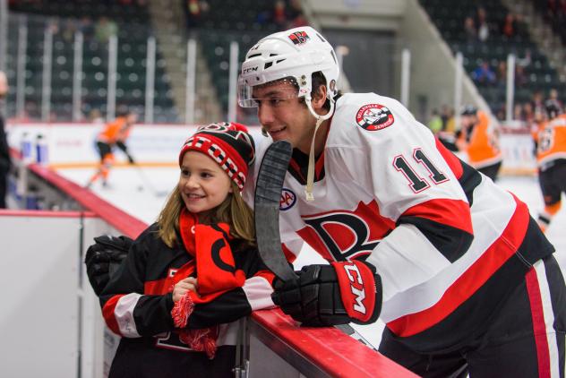 Belleville Senators left wing Vitaly Abramov poses with a young fan