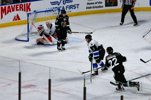 Utah Grizzlies forward Josh Dickinson (lower right) snaps off a shot against the Wichita Thunder