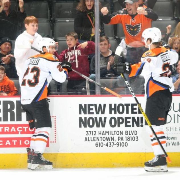 Morgan Frost of the Lehigh Valley Phantoms (left) celebrates his first goal