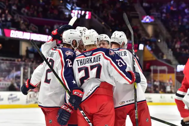 Cleveland Monsters huddle after a goal against the Rockford IceHogs