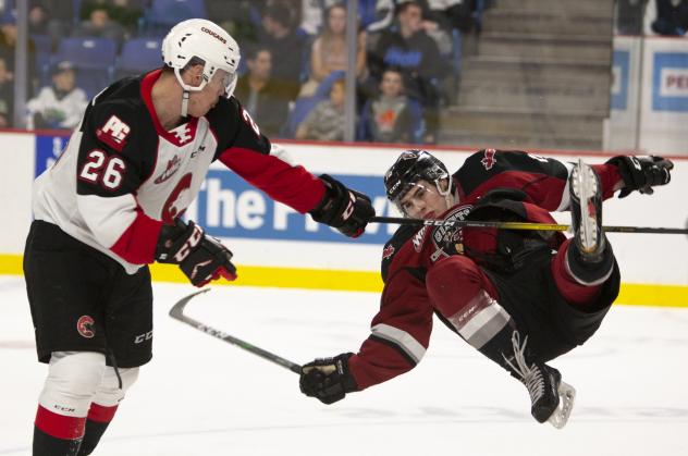 Vancouver Giants left wing Jackson Shepard is thrown to the ice by the Prince George Cougars
