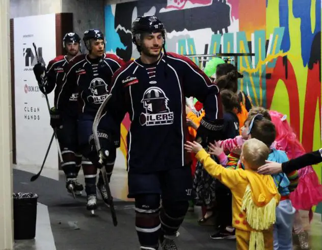 Young fans in their Halloween costumes greet the Tulsa Oilers