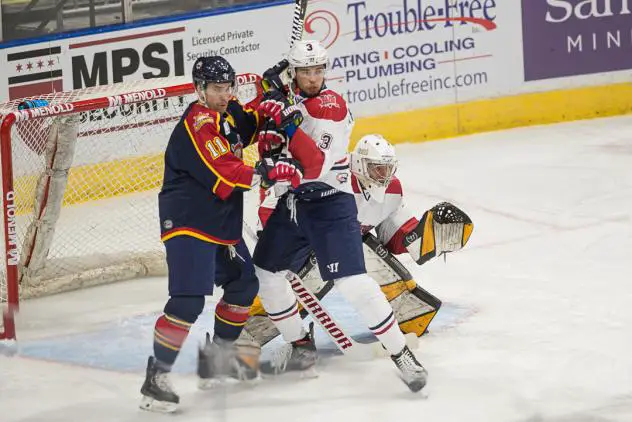 Macon Mayhem defenseman Oleg Khalemin battles the Peoria Rivermen in front of Macon goaltender Kevin Entmaa