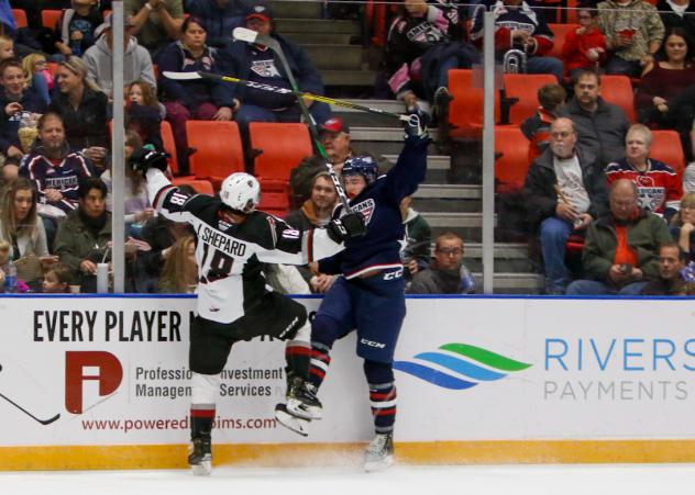 Jackson Shepard of the Vancouver Giants collides with a Tri-City Americans player along the boards