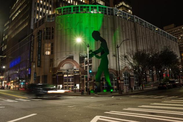 Hammering Man glows Rave Green in support of Seattle Sounders FC