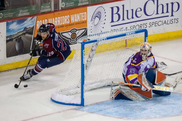 Tulsa Oilers forward Ryan Tesink handles the puck behind the Wichita Thunder net