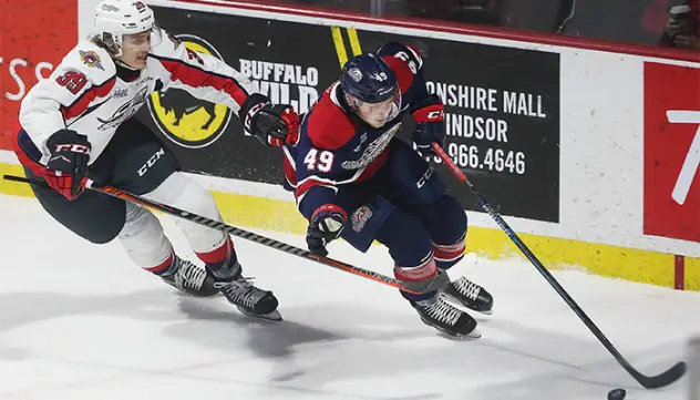Saginaw Spirit right wing Cole Coskey (right) vs. the Windsor Spitfires