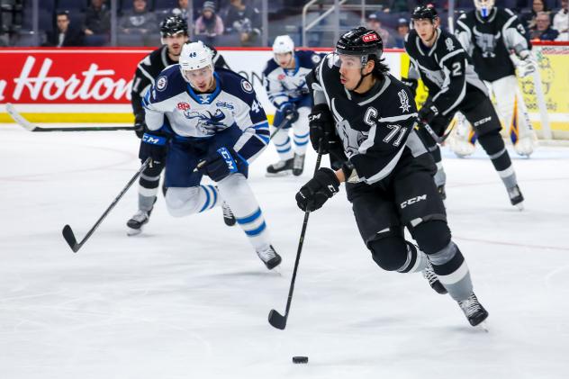 Jordan Nolan of the San Antonio Rampage with the puck against the Manitoba Moose