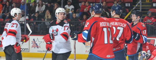 Marian Studenic (left) and Egor Sharangovich of the Binghamton Devils eye the Springfield Thunderbirds