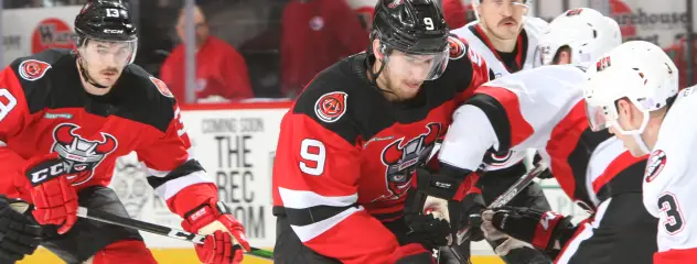 Binghamton Devils centre Michael McLeod battles against the Belleville Senators