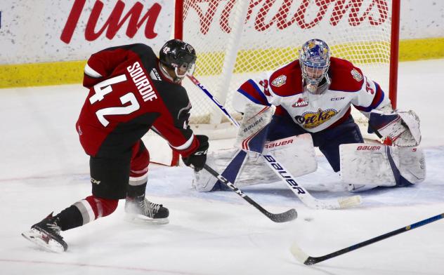 Vancouver Giants centre Justin Sourdif (left) shoots against the Edmonton Oil Kings